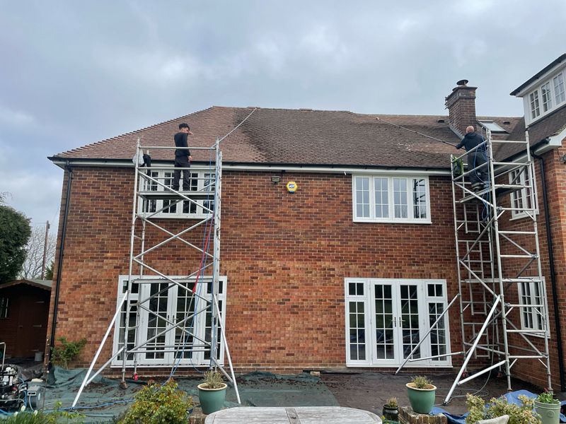 Roof cleaning carried out safely from scaffold towers by The Roof Moss Cleaners in Witley